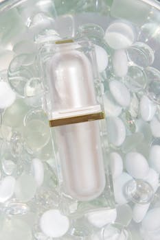 Luxurious cosmetic bottle placed among translucent beads for a high-end product display.