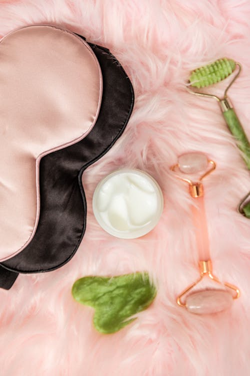 Free Beauty Products over Pink Furry Fabric Stock Photo