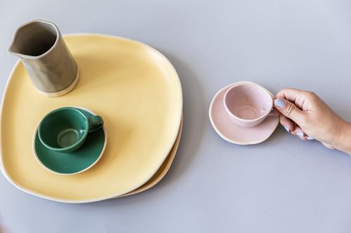 Free Aerial view of modern ceramic tableware with pastel shades on a flat surface. Stock Photo