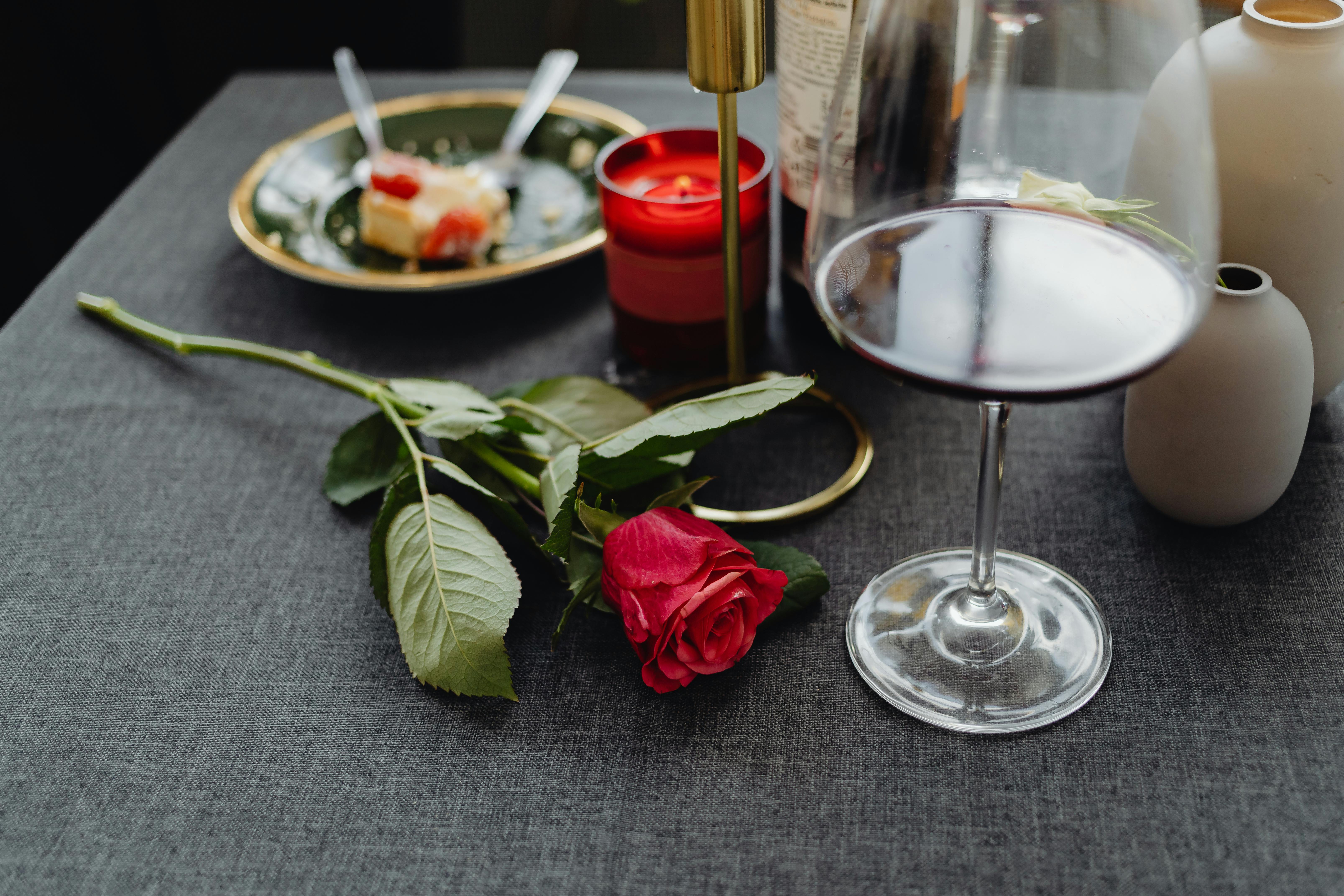 Rose wine glasses and bottles on table served for festive dinner party  Stock Photo by Olga_Kochina