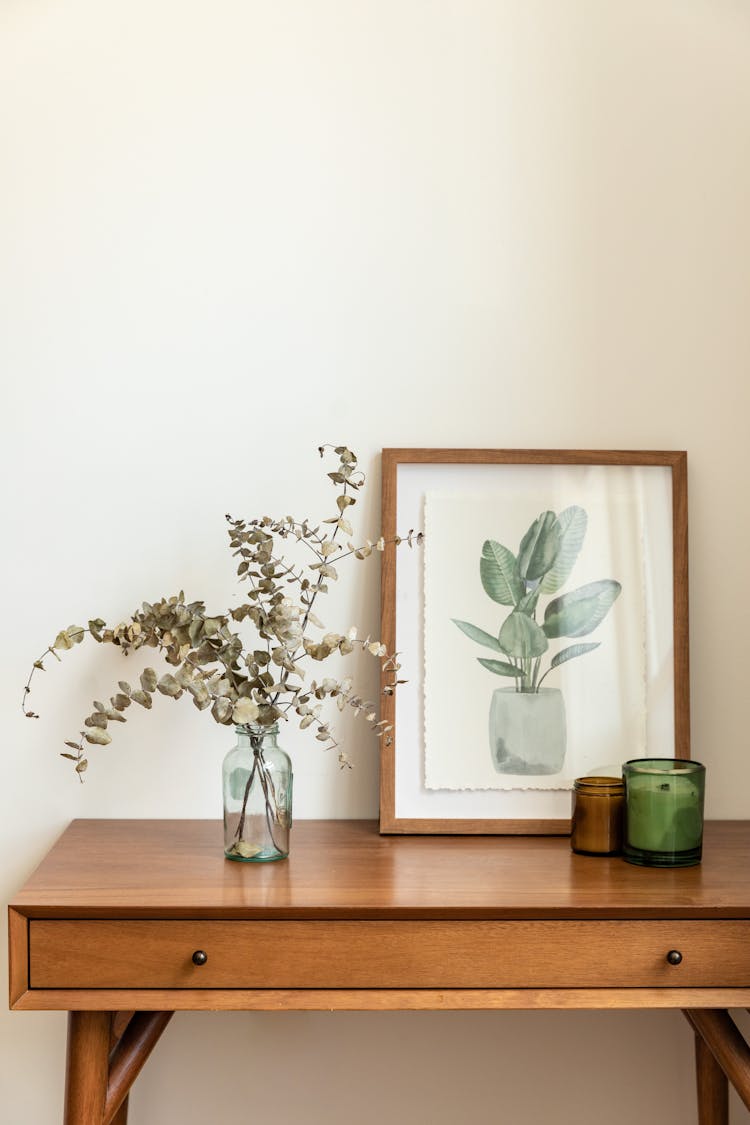 Eucalyptus Leaves On Vase On Brown Wooden Table