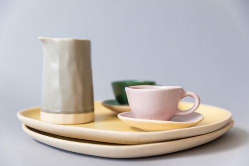 Free Close-up of elegant pastel ceramic plates and cups showcasing pottery craft. Stock Photo