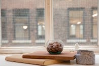 Small Flowers on a Glass Bowl on Top of Stacked Books