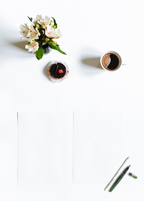 Free Food and Dink Beside a Flower Vase on White Surface Stock Photo