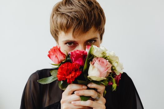 Woman in Black Blazer Holding Red and White Rose Bouquet