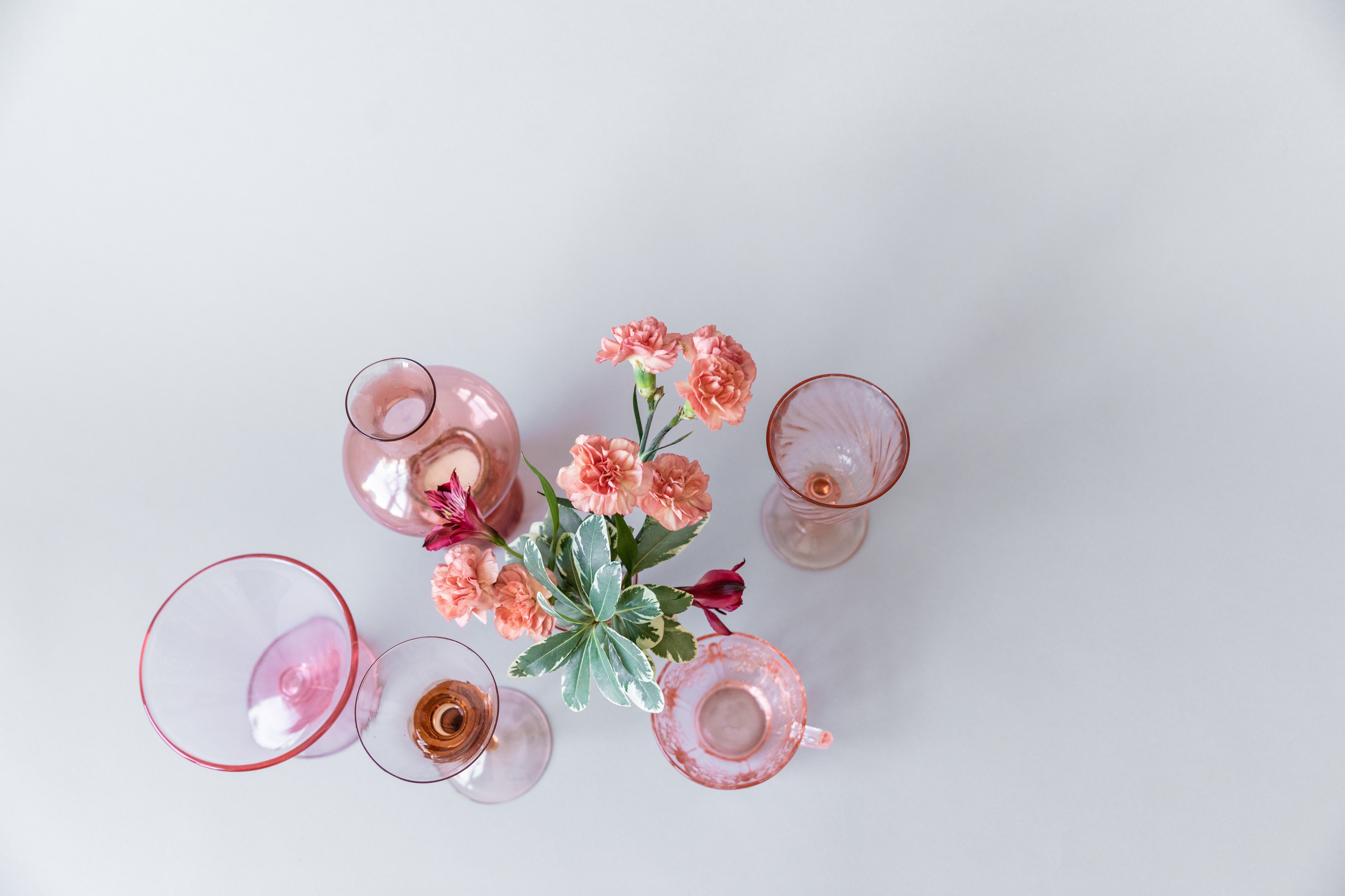 Dyed silk ribbons tied around mismatched thrifted vases as a low-cost centerpiece swap