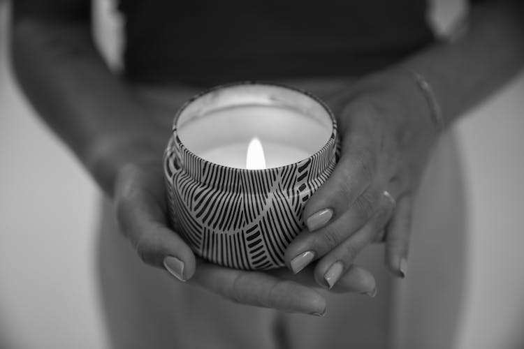 Grayscale Photo Of Person Holding Lighted Candle