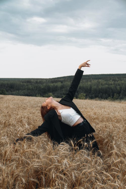 Photo of a Woman Posing in the Middle of a Wheat Field