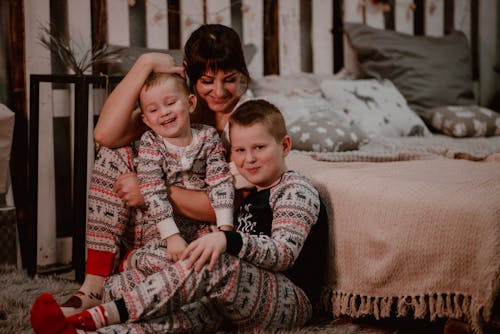 Mother and Sons Wearing Matching Christmas Pajamas