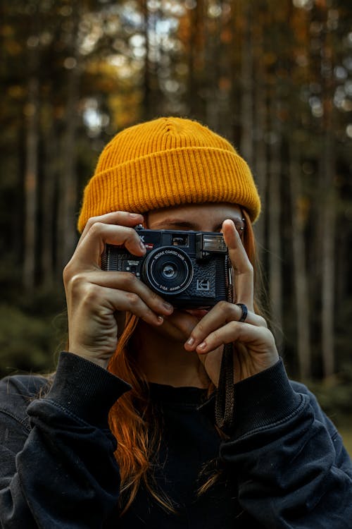 Portrait of a Woman with a Beanie Using a Camera