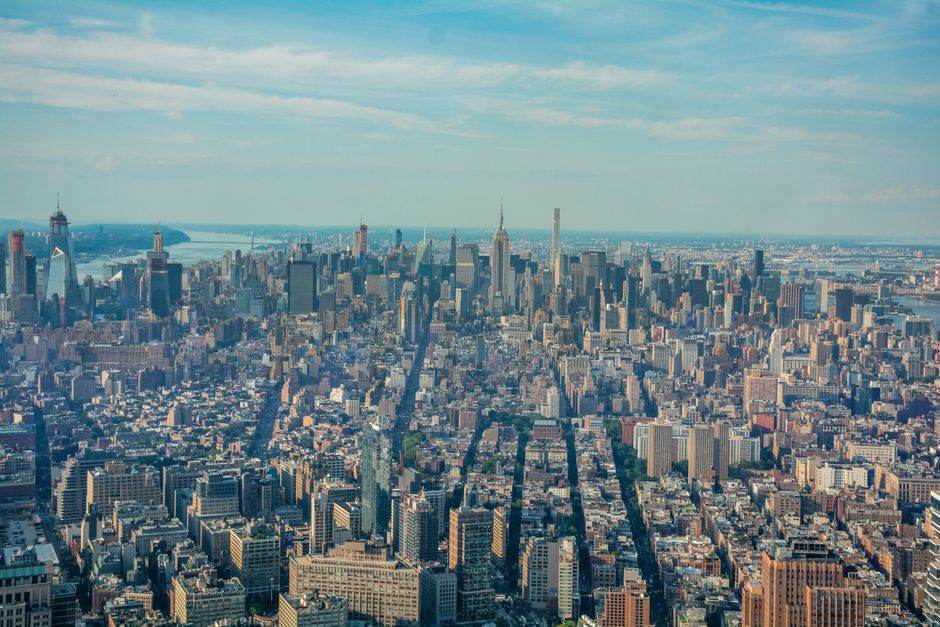 Breathtaking Private Sunset Helicopter Tour around Manhattan from New Jersey Review Review 2026 - Breathtaking aerial shot of New York City skyline with iconic skyscrapers and Hudson River under a blue sky.