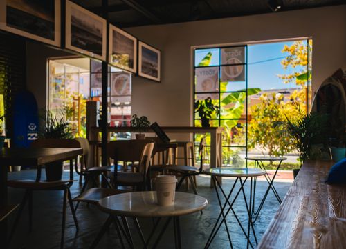 Free Warm and inviting modern cafe interior in Sochi, featuring natural light and comfortable seating. Stock Photo