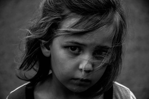 Free Monochrome close-up portrait capturing a thoughtful young girl with expressive eyes. Stock Photo