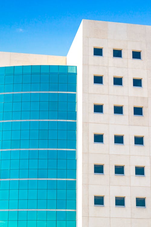 Blue and White Concrete Building with Glass Windows 