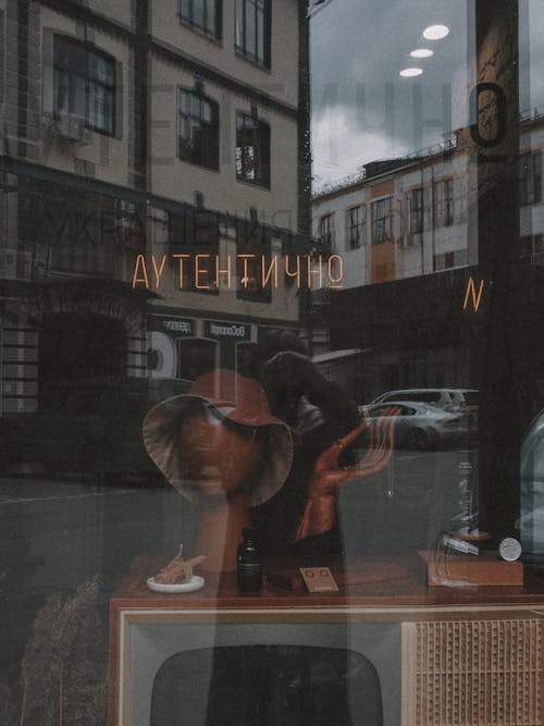 Photo of Window Display of Antique Items Through a Clear Glass