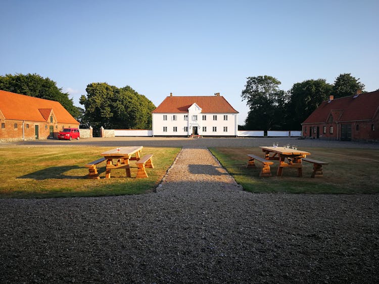 Tables In Yard Of Old Farmhouse Building