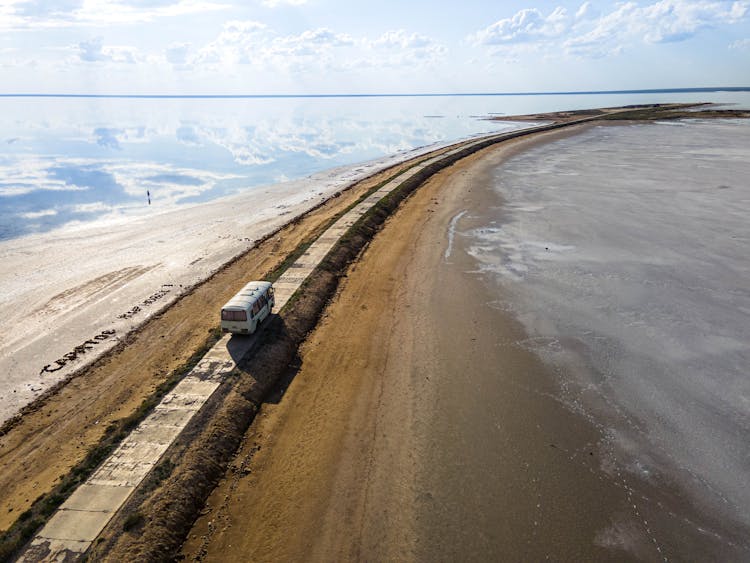 A Bus On A Road By A Sea