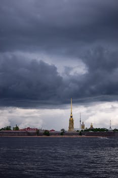 A moody view of Saint Petersburg's riverside with looming clouds above iconic landmarks. Captured with a NIKON D5300.