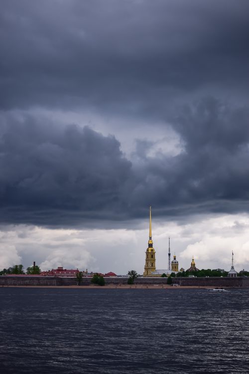 Free A moody view of Saint Petersburg's riverside with looming clouds above iconic landmarks. Captured with a NIKON D5300. Stock Photo