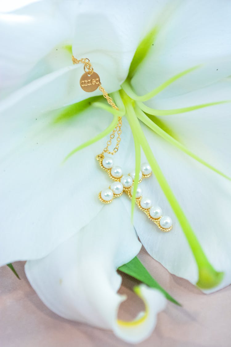 Gold And Pearls Cross Pendant On White Flower