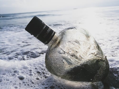 Free Clear Glass Bottle on Body of Water Stock Photo