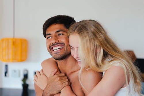 Free Woman Smiling while Hugging a Man Stock Photo