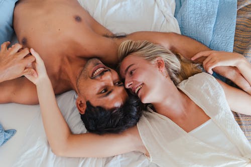 Overhead Shot of a Couple Lying while Smiling Together