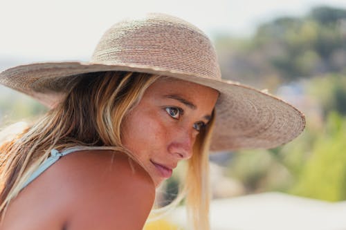 Close-Up Shot of a Pretty Woman Wearing a Sun Hat