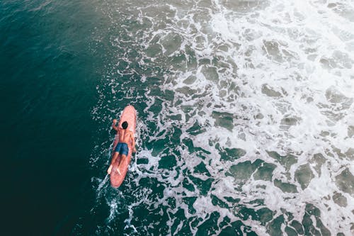Drone Shot of a Man on Surfboard