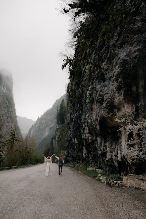A Couple Walking Near the Mountain