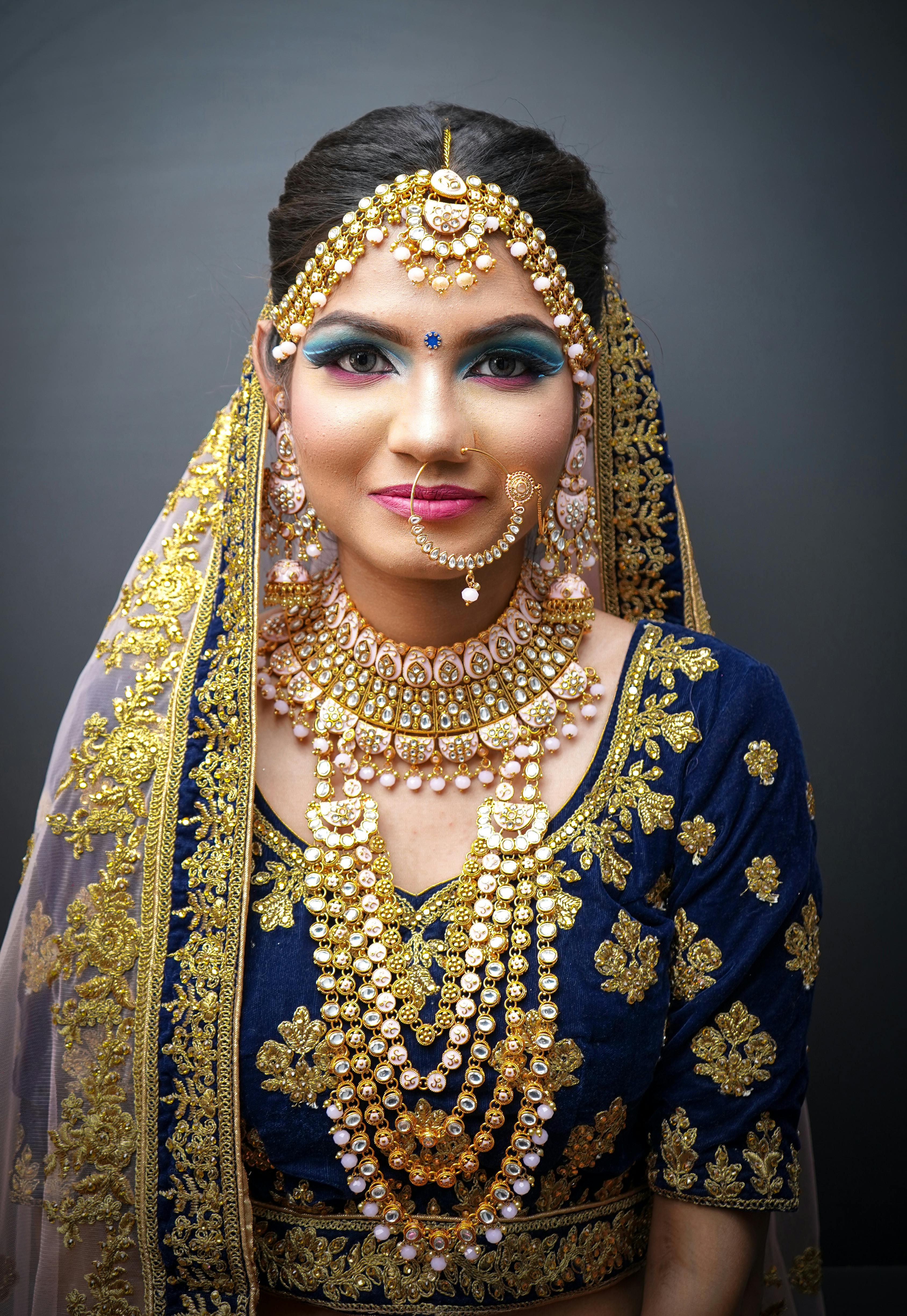 Portrait of an elegant Indian woman in traditional attire with intricate jewelries.