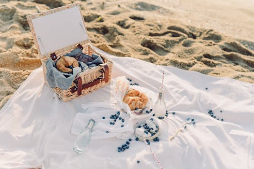 A serene beach picnic with fresh croissants and blueberries.