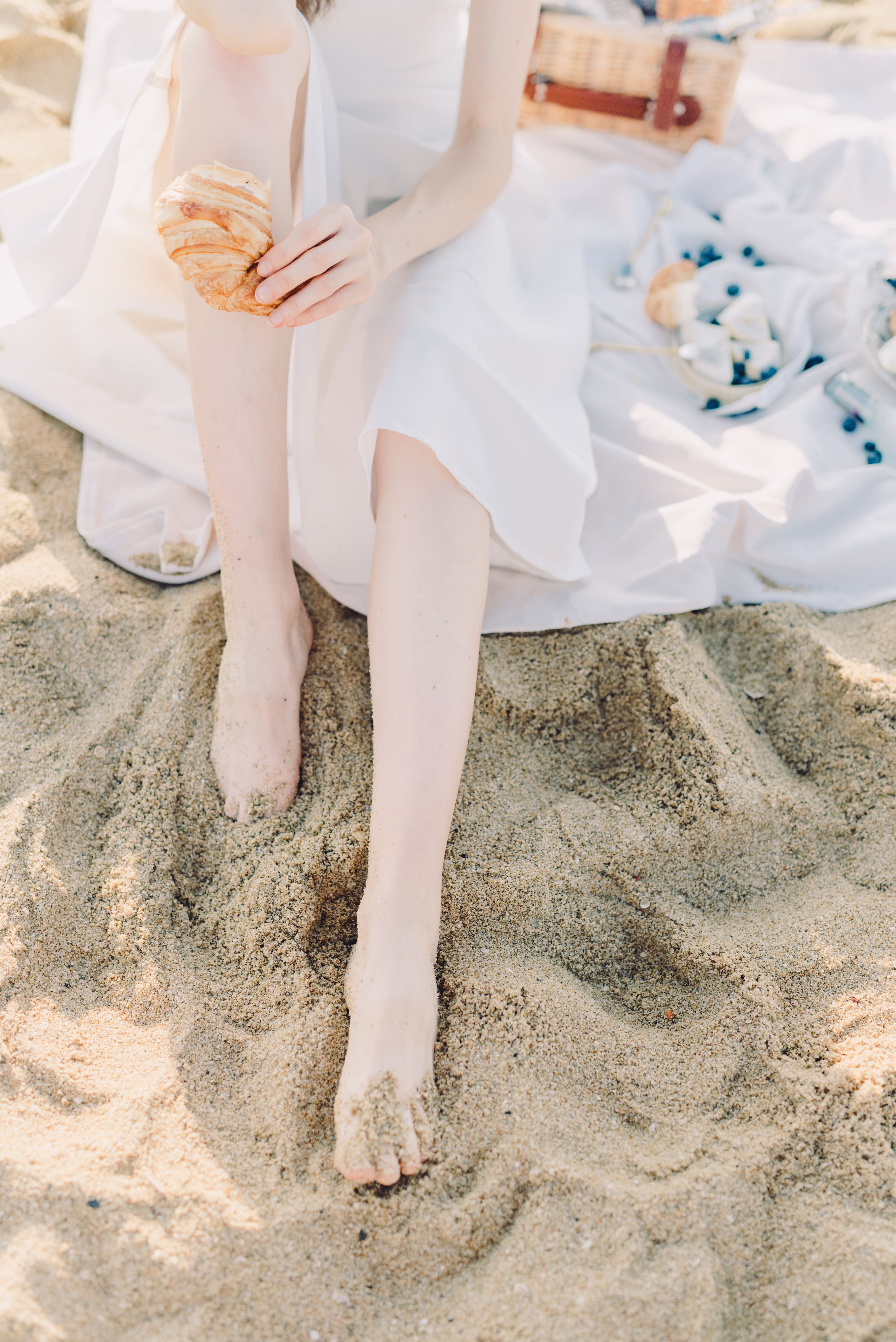 A Woman in White Dress Sitting on the Sand · Free Stock Photo