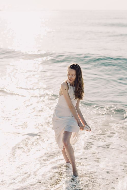 Woman in White Dress Walking on Sea Water · Free Stock Photo