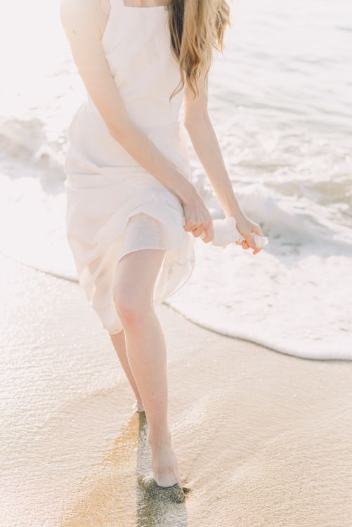 Woman in White Dress Walking on Beach · Free Stock Photo