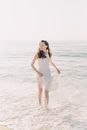 Woman in White Dress Standing on Beach