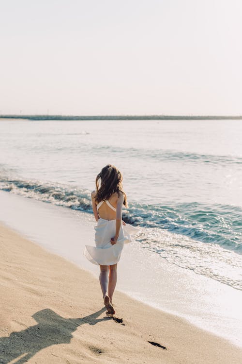 A Woman Walking on the Beach