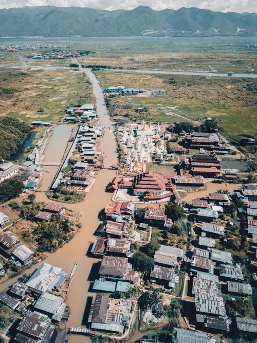 Free Dramatic aerial view of Shan, Myanmar showcasing rooftops, rivers, and rural landscape. Stock Photo