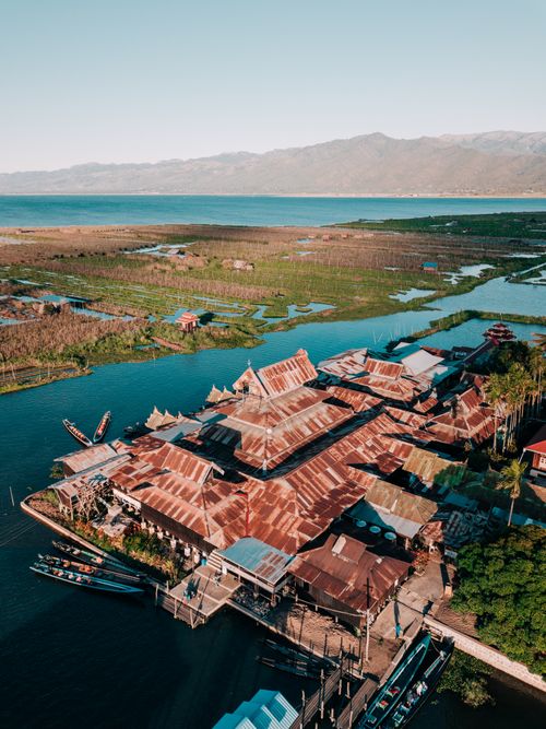 Free Beautiful aerial shot of a rustic village by a lake in Shan, Myanmar. Stock Photo