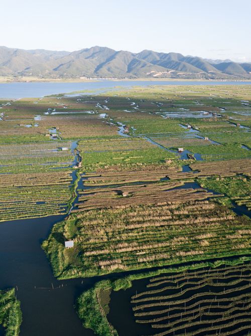 Free Stunning aerial photo of floating farms in Shan State, Myanmar. Features lush fields and serene water channels. Stock Photo