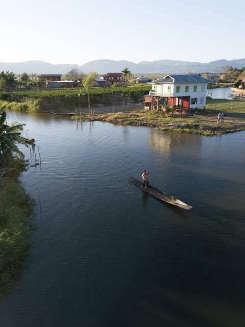 Free A tranquil scene of a local navigating a boat on Inle Lake in Myanmar. Stock Photo