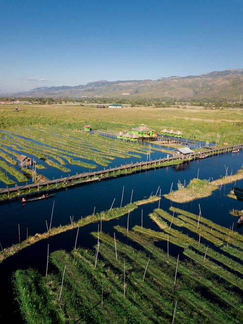 Free Scenic aerial view of Shan countryside with floating farms and stilt houses in Myanmar. Stock Photo