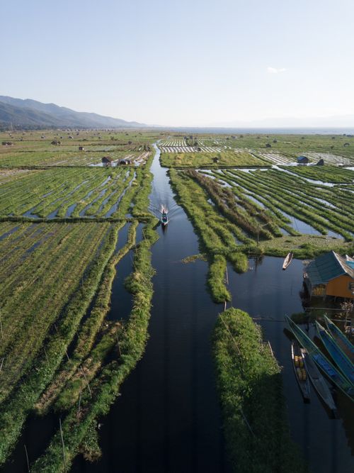 Free Drone shot of tranquil floating gardens at Inle Lake in Myanmar. Stock Photo