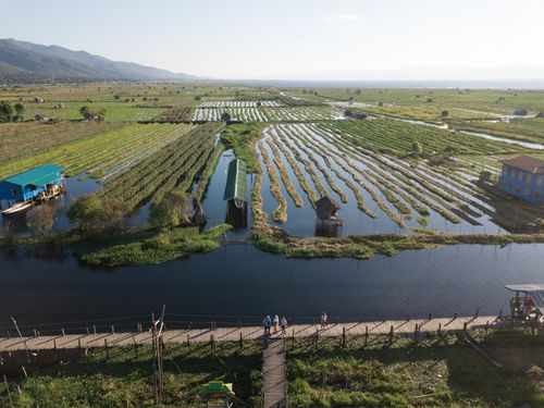 Free Scenic aerial photo of floating gardens and waterways in Shan State, Myanmar, under a clear blue sky. Stock Photo