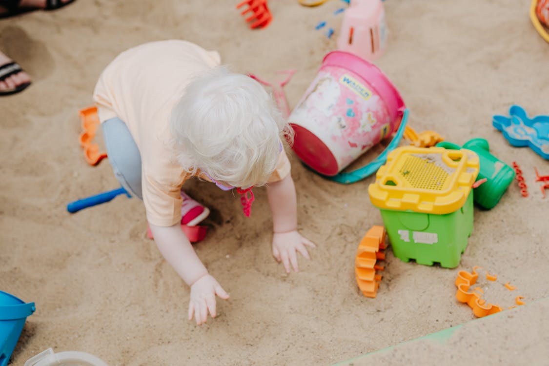 Free A Toddler Playing in the Sand Stock Photo