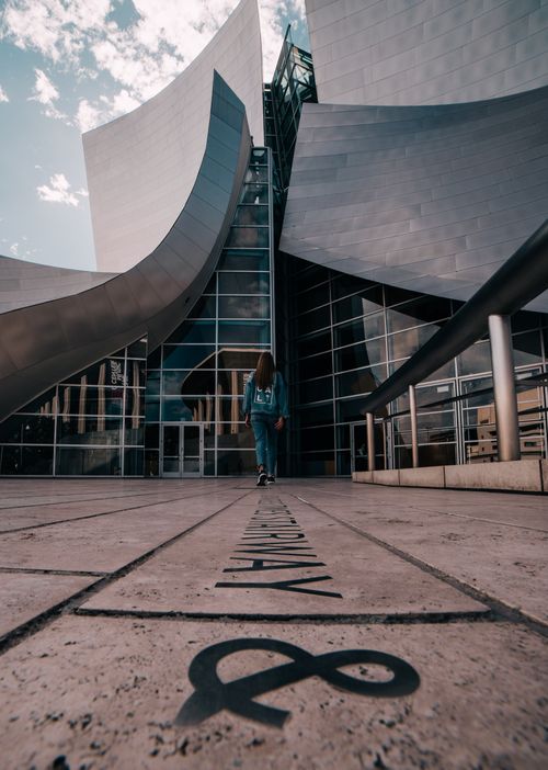 Free A woman explores the modern architecture of Walt Disney Concert Hall in Los Angeles. Stock Photo