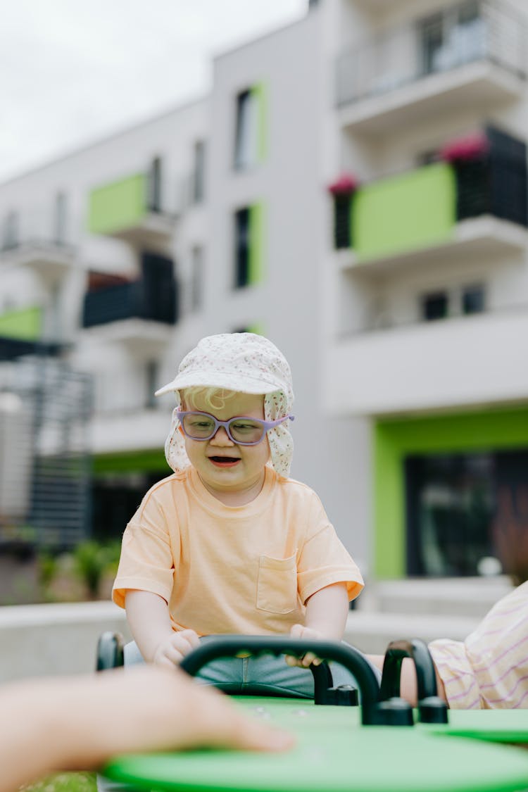 A Young Girl Playing In The Playground