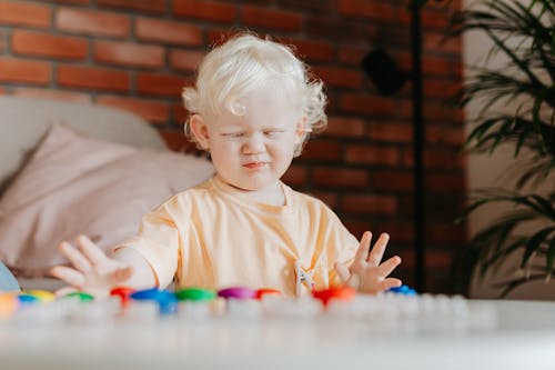 Free Baby Girl in Crew Neck Shirt Playing Toys  Stock Photo
