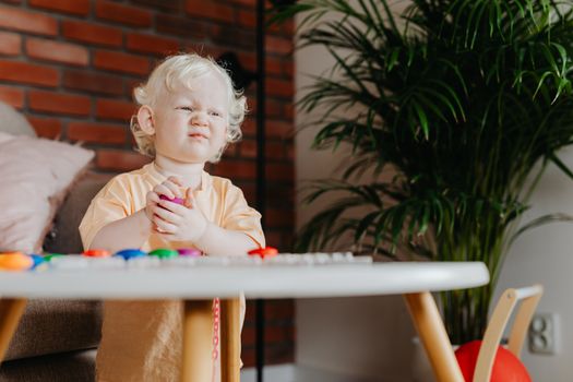 Girl in Orange Shirt Playing Near Round Table 