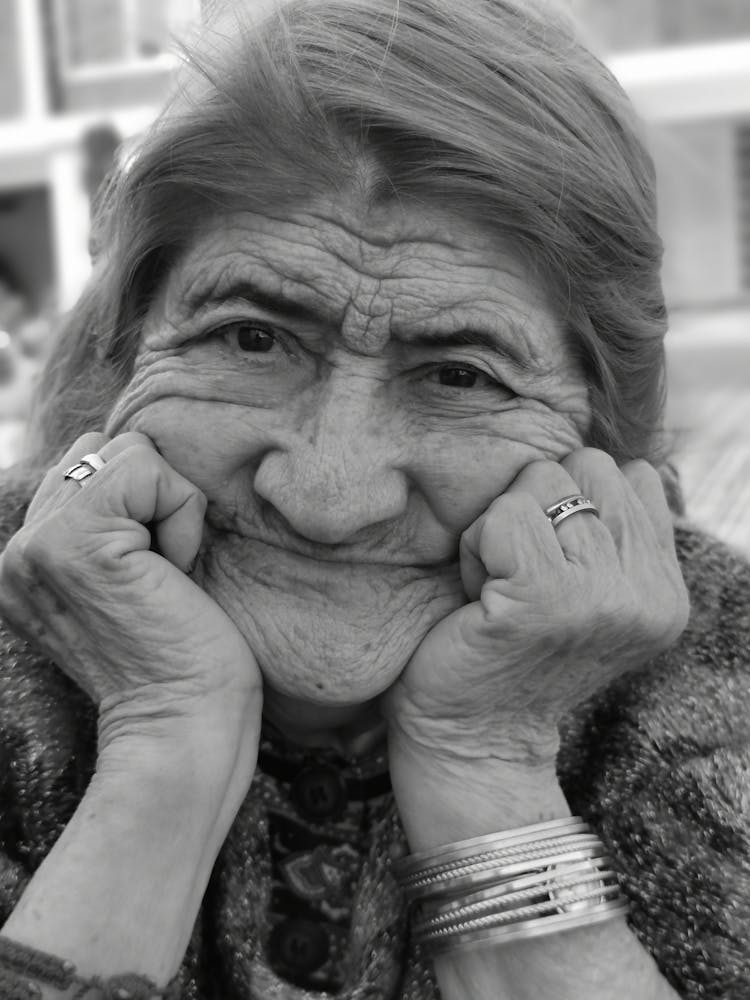 Elderly Woman With Hands On Cheeks